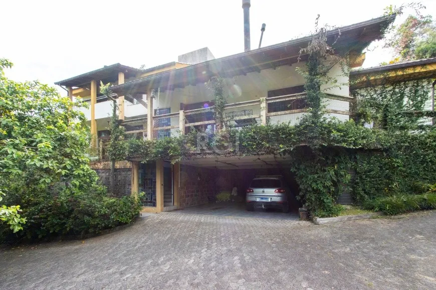 Foto 1 de Casa com 5 Quartos à venda, 463m² em Vila Nova, Porto Alegre