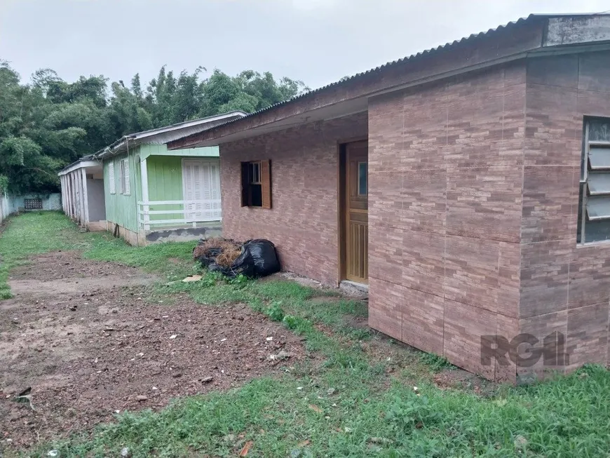 Foto 1 de Casa com 7 Quartos à venda, 241m² em Vila Nova, Porto Alegre