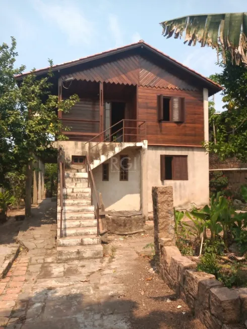 Foto 1 de Casa com 4 Quartos à venda, 189m² em Vila Nova, Porto Alegre